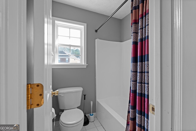 bathroom with a textured ceiling, toilet, tile patterned flooring, and shower / bath combo with shower curtain