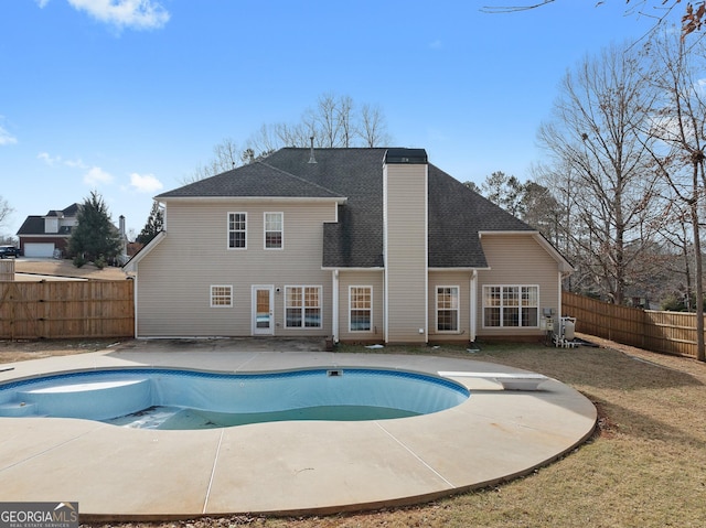 view of pool with a patio area and a yard