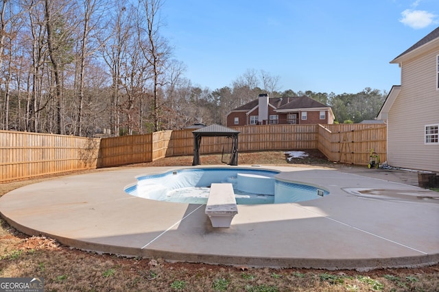 view of pool featuring a patio area, a gazebo, and a diving board