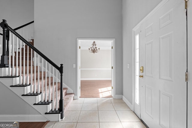 foyer entrance featuring an inviting chandelier and light tile patterned flooring