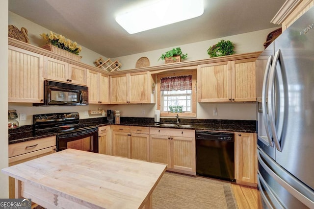 kitchen featuring sink, light brown cabinets, black appliances, and butcher block counters