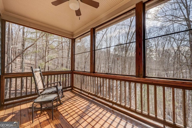 unfurnished sunroom with ceiling fan and a wealth of natural light