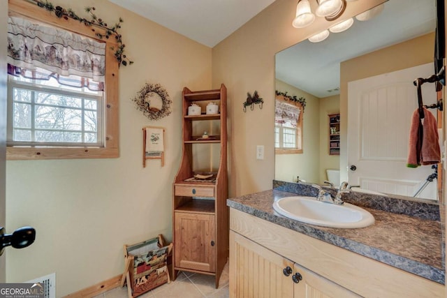 bathroom featuring tile patterned floors, vanity, and toilet