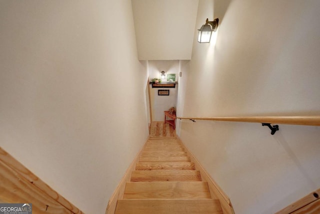 staircase featuring wood-type flooring