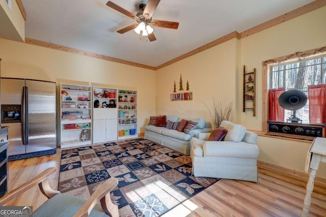 living room featuring ceiling fan, ornamental molding, and hardwood / wood-style floors