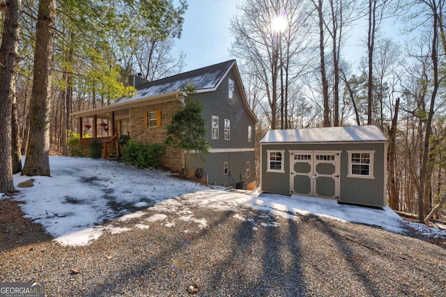 view of front of house with an outbuilding, central AC unit, and a garage