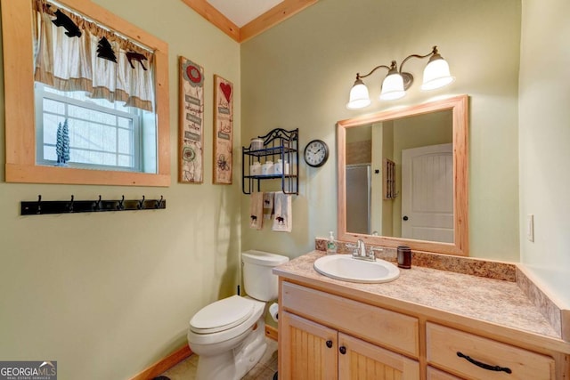 bathroom with toilet, vanity, and an enclosed shower