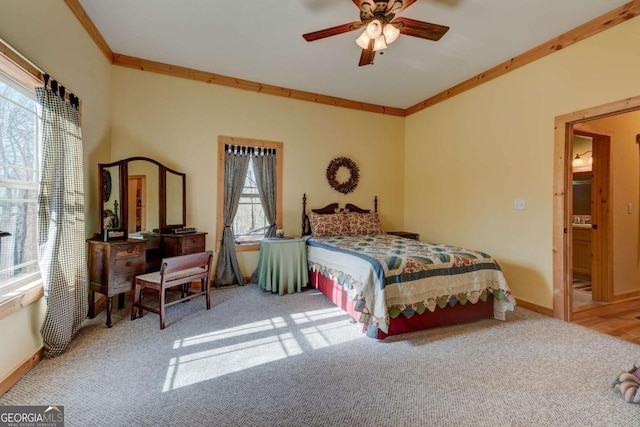 carpeted bedroom featuring ceiling fan, multiple windows, and ornamental molding