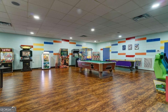 game room with billiards, a paneled ceiling, and dark wood-type flooring