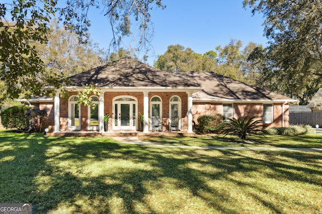 ranch-style house featuring a front lawn, french doors, and covered porch