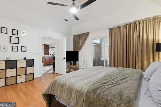 bedroom featuring ceiling fan, light hardwood / wood-style flooring, and access to outside