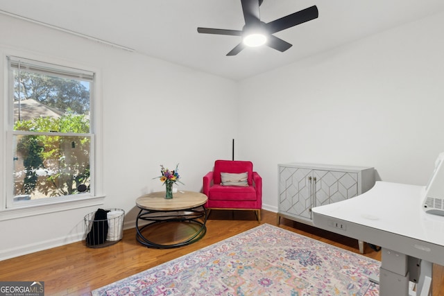 sitting room featuring ceiling fan, a wealth of natural light, and hardwood / wood-style flooring