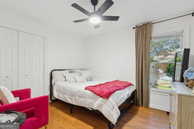 bedroom featuring ceiling fan, a closet, and hardwood / wood-style floors