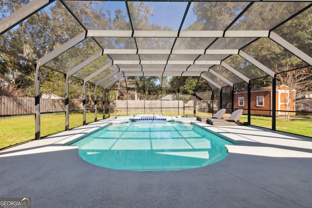 view of swimming pool featuring glass enclosure, a shed, and a yard