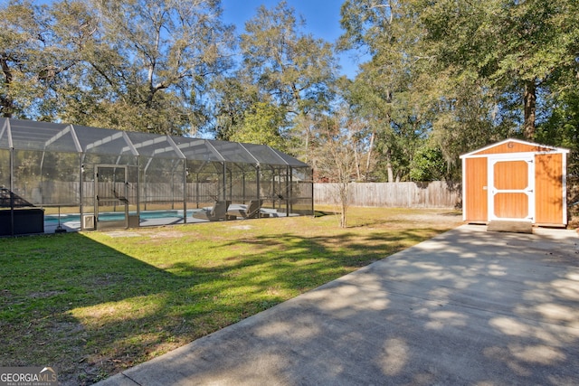 view of yard featuring a lanai, a fenced in pool, a patio, and a shed