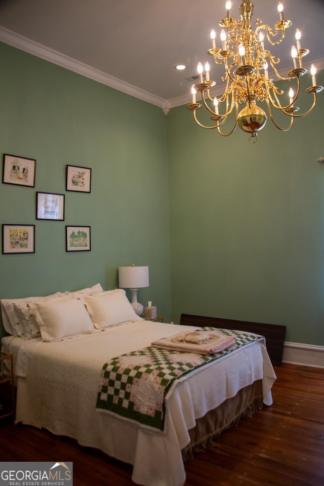 bedroom with an inviting chandelier, dark hardwood / wood-style flooring, and crown molding