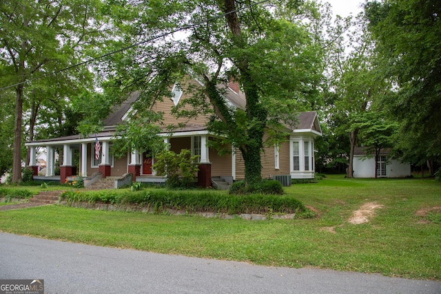 view of front of home with covered porch and a front yard