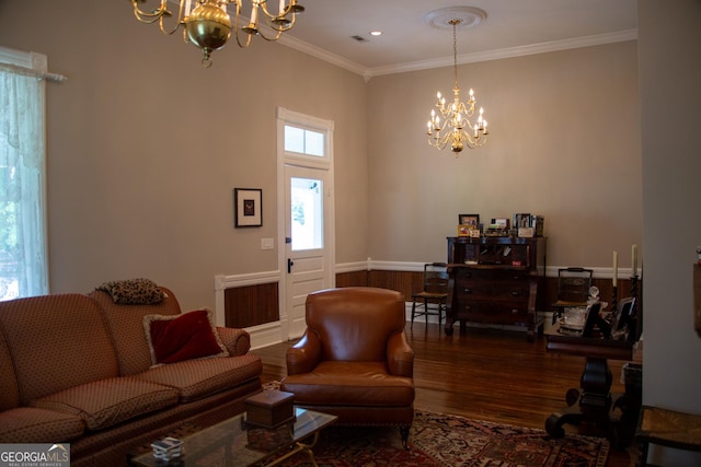 living room with crown molding, a chandelier, and hardwood / wood-style flooring