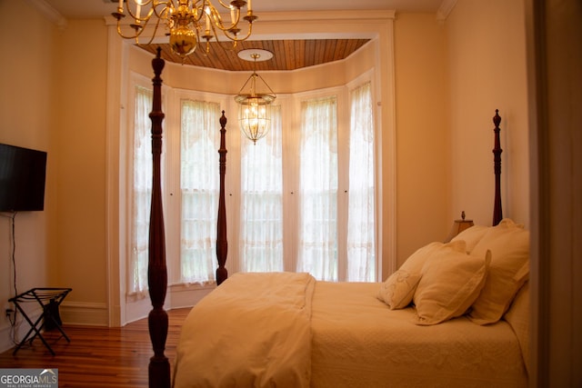 bedroom with a chandelier, ornamental molding, and wood-type flooring