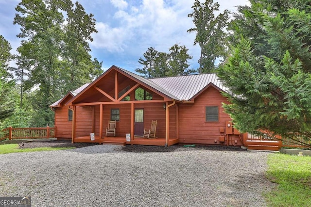 log-style house with covered porch