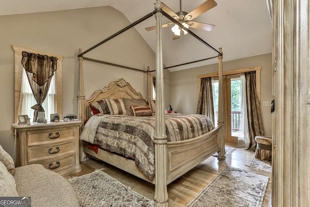 bedroom featuring access to outside, ceiling fan, vaulted ceiling, and light hardwood / wood-style flooring