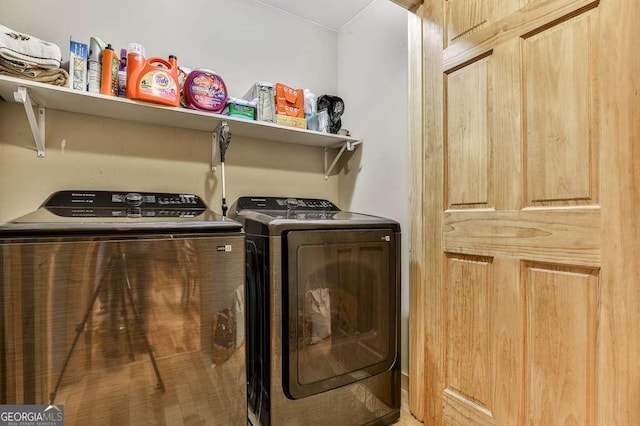 clothes washing area with washing machine and clothes dryer