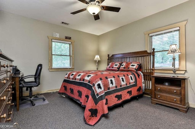 carpeted bedroom featuring ceiling fan and multiple windows