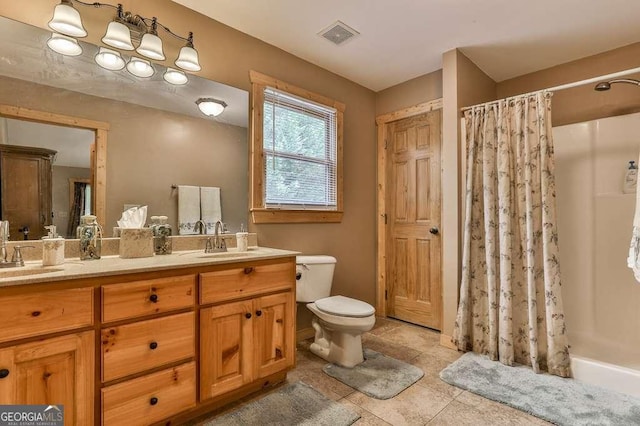 bathroom with toilet, vanity, and a shower with shower curtain