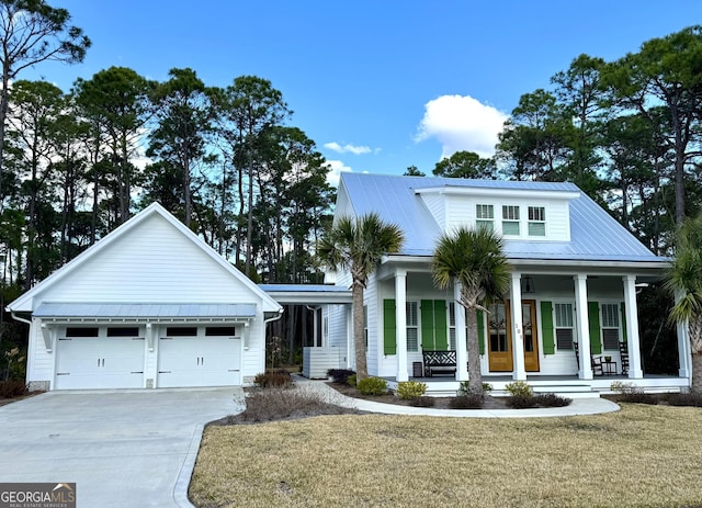 view of front of property featuring a garage, a front lawn, and covered porch