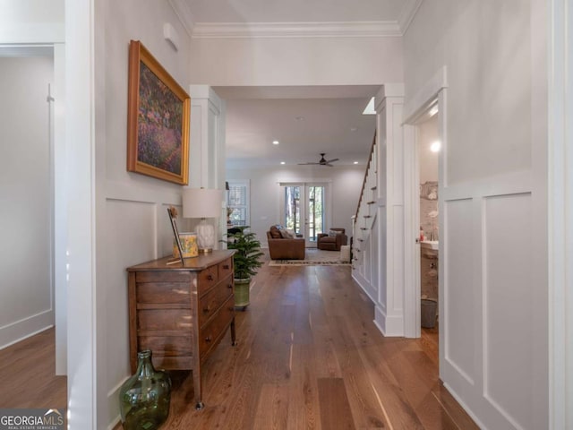 hallway featuring ornamental molding, hardwood / wood-style floors, and french doors