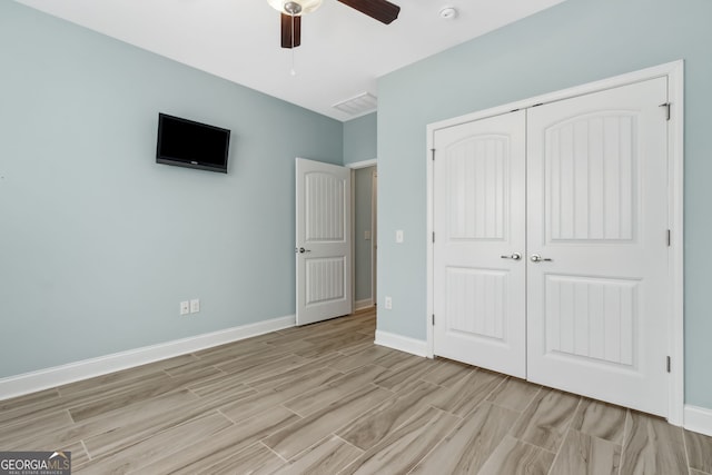 empty room featuring visible vents, baseboards, ceiling fan, and wood finished floors