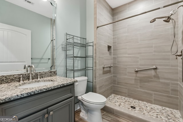 unfurnished bedroom with a closet, wood tiled floor, ceiling fan, and baseboards