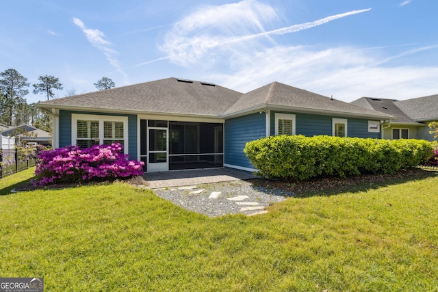 view of side of property with a lawn, fence, and roof with shingles