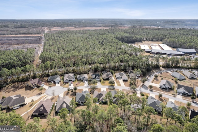 drone / aerial view featuring a view of trees
