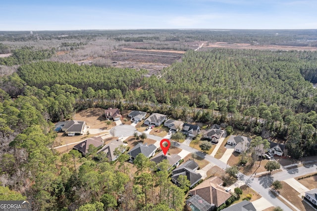 birds eye view of property with a residential view and a forest view