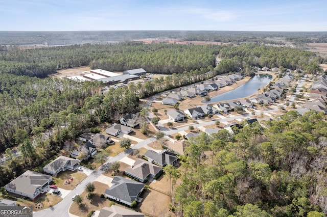 drone / aerial view featuring a view of trees and a residential view