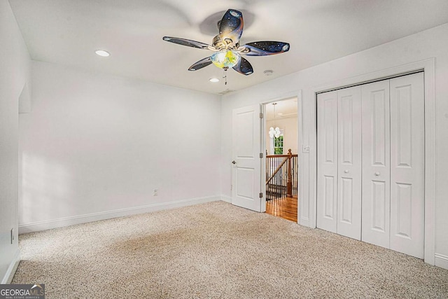 unfurnished bedroom featuring ceiling fan, a closet, and carpet floors