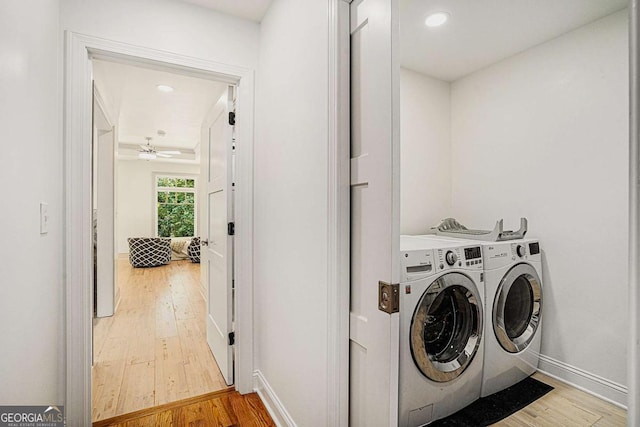 laundry area with ceiling fan, washer and dryer, and hardwood / wood-style floors