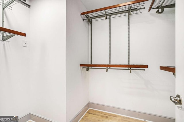 walk in closet featuring hardwood / wood-style floors