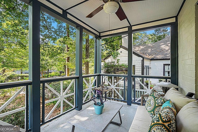 unfurnished sunroom featuring ceiling fan