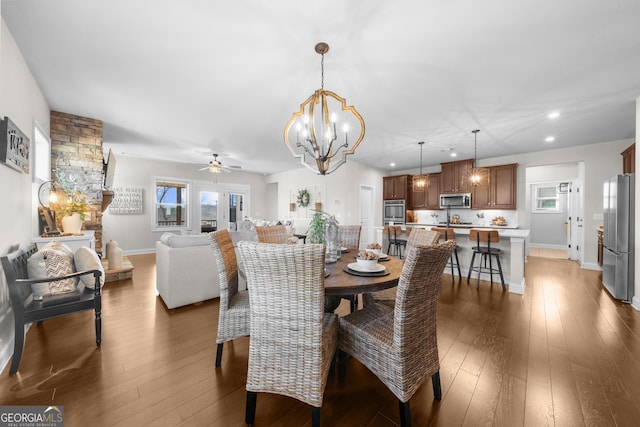 dining area with recessed lighting, ceiling fan with notable chandelier, and dark wood-style flooring