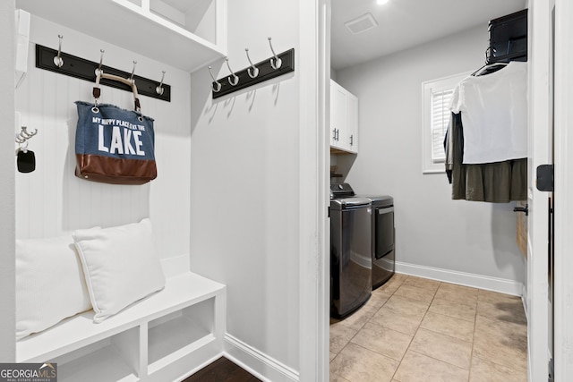 mudroom featuring light tile patterned floors and separate washer and dryer