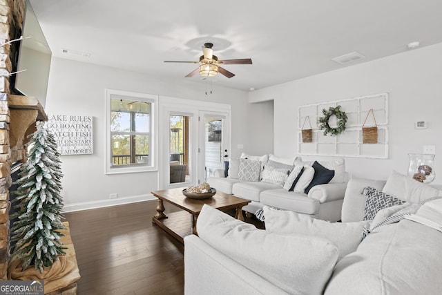 living room featuring dark hardwood / wood-style flooring and ceiling fan