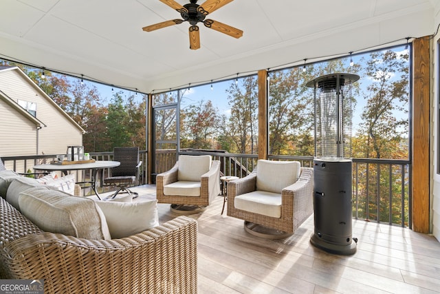 sunroom / solarium featuring ceiling fan