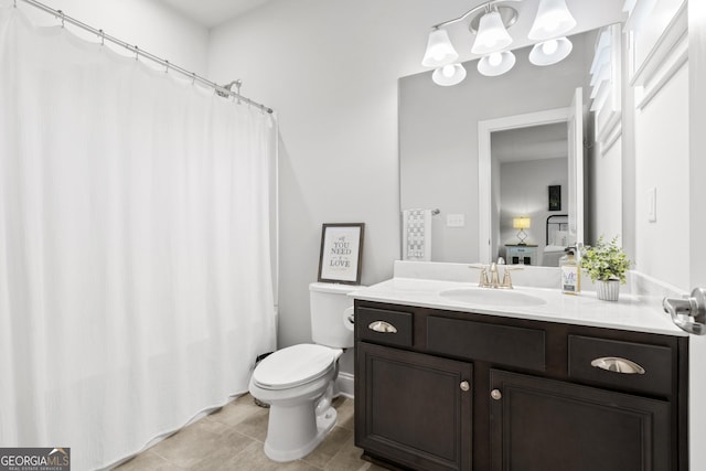 ensuite bathroom featuring connected bathroom, toilet, vanity, and tile patterned flooring