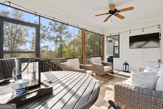 sunroom / solarium featuring ceiling fan and a wealth of natural light