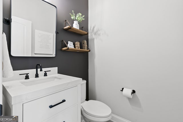 bathroom with toilet and vanity