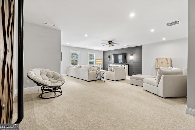 carpeted living area featuring recessed lighting, visible vents, baseboards, and a ceiling fan