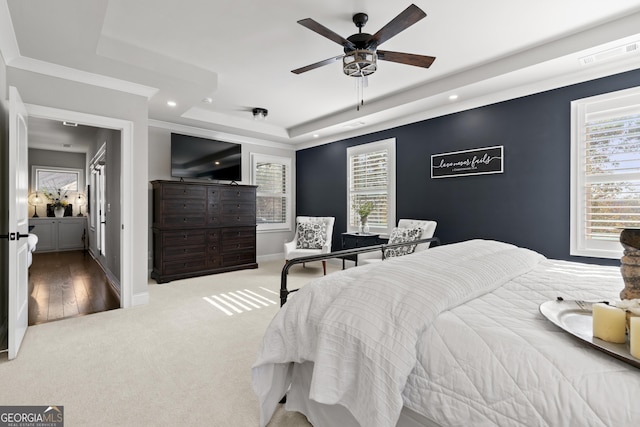 carpeted bedroom with recessed lighting, baseboards, a raised ceiling, and visible vents