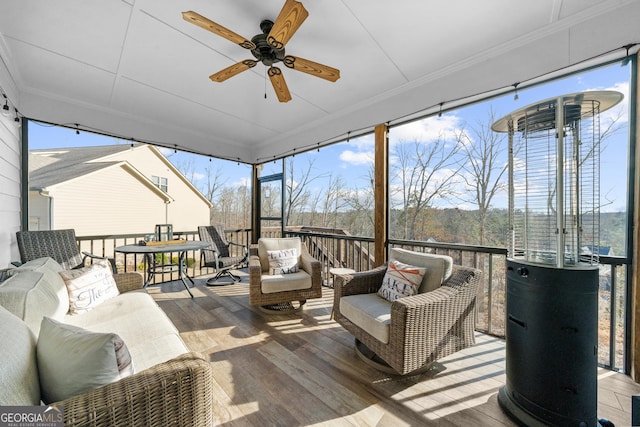 sunroom / solarium with a ceiling fan